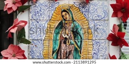 Image of the Virgin of Guadalupe embodied on tiles, with flowers around Royalty-Free Stock Photo #2113891295