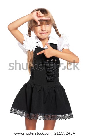 Portrait of happy little girl making a frame by her hands, isolated on white background