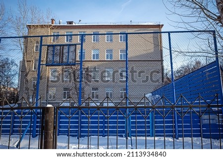School building with basketball court on a winter day