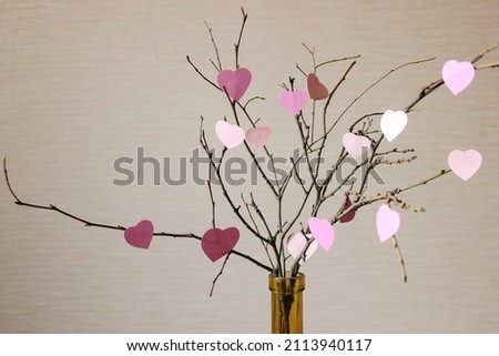 Happy Valentine's Day. Roze elements hanging on the branch for invitation or poster. Festive tree with paper heart shaped leaves