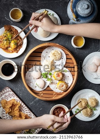 Two friends having a cantonese dim sum brunch. Top view.  Royalty-Free Stock Photo #2113963766