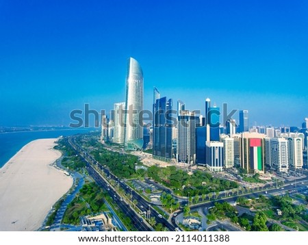 Aerial view of Downtown Abu Dhabi skyscrapers along the city beach on a sunny day