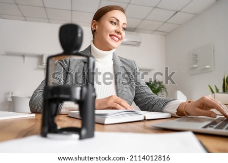 Female notary public working in office Royalty-Free Stock Photo #2114012816