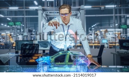 Sustainable Industrial Design: Portrait of Modern Automotive Engineer Using Augmented Reality to Construct 3D Hologram Model of High-Tech Electric Car. Automated Vehicle Manufacturing Facility