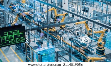 Car Factory Digitalization Industry 4.0 5G IOT Concept: Automated Robot Arm Assembly Line Manufacturing High-Tech Electric Vehicles. AI Computer Vision Analyzing, Scanning Production Efficiency Royalty-Free Stock Photo #2114019056
