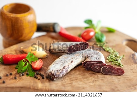 Fresh meat products and vegatables on a wooden plates