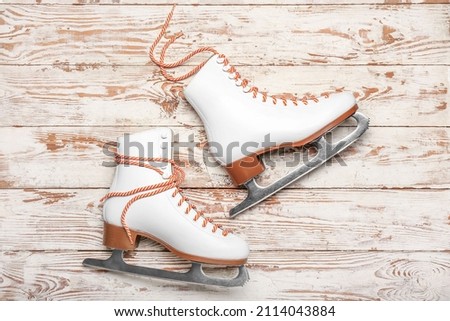 Ice skates on light wooden background