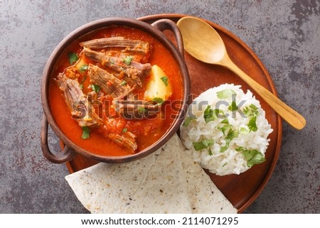 Hilachas traditional dish of Guatemalan cuisine, rice, potatoes, tomato sauce, and tortillas closeup in the plate on the table. Horizontal top view from above Royalty-Free Stock Photo #2114071295