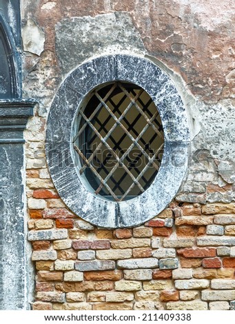 Closed windows on the ancient wall of the house - Venice, Italy