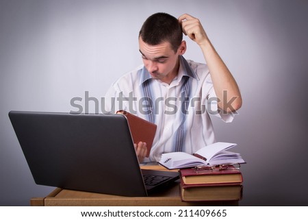 Puzzled young businessman considering a book at your workstation, Spend neck hand