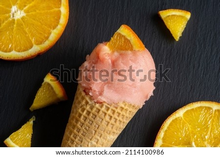 orange fruit ice cream in waffle, sorbet in cone