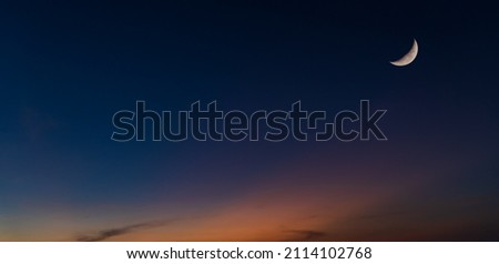 Dusk sky Twilight in the evening after sundown and crescent moon symbol of religion Islamic well text Ramadan Kareem on free space Royalty-Free Stock Photo #2114102768