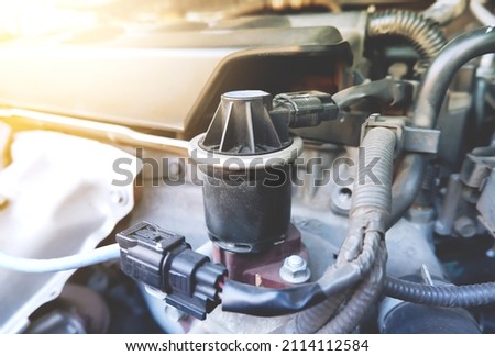 Close up of The old Exhaust gas recirculation (EGR) in the engine compartment to reduce the carbon monoxide gas from the exhaust. automotive part concept. Royalty-Free Stock Photo #2114112584