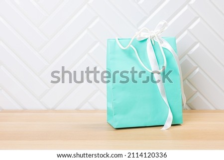 Paper bags on wooden table against white background, copy space. Commercial, sale and advertisement concept. Mock up