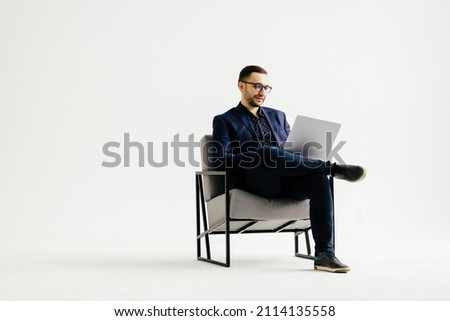 Pleasant positive business man using laptop