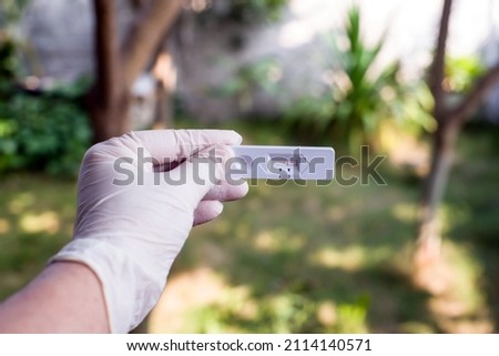 Hand  holding Rapid Antigen Test kit with Negative result during swab COVID-19 testing. Coronavirus Self nasal at Home test