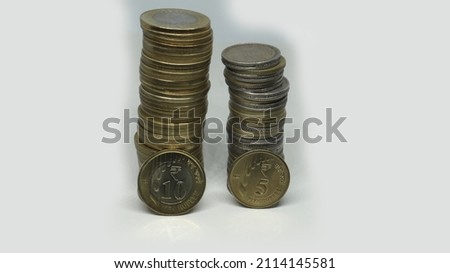 Indian Rupee Coins. ten rupees coins and five rupees coin stacked vertically. On a white background