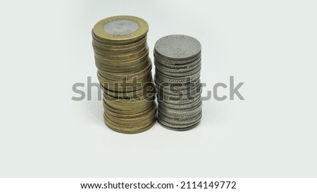 Pile of Indian Rupee Coins. Ten rupee and five rupee coins. On a white background