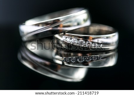 Wedding day details - two lovely golden wedding rings awaiting their moment, with some nice reflections