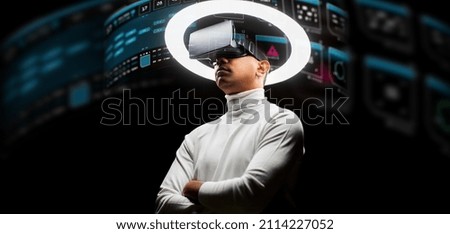 future technology, augmented reality and cyberspace concept - man in vr glasses under white illumination with virtual screens projection over black background