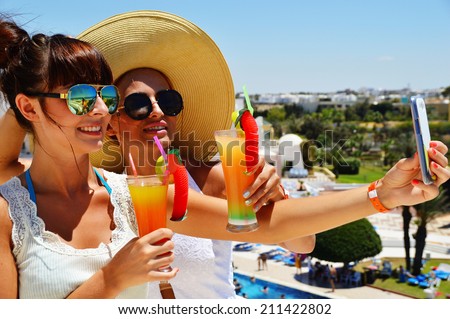 Two young women taking picture of themselves on vacation. Selfie on holiday