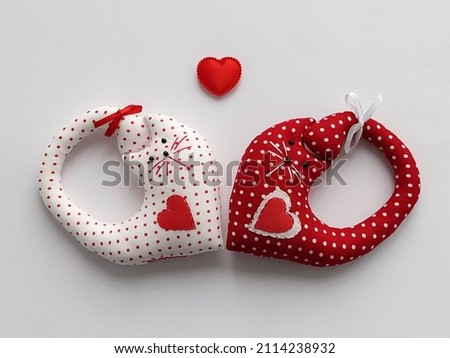 Two soft toy two cute cats with red hearts. Handmade gift for Valentine's Day or Wedding. Royalty-Free Stock Photo #2114238932