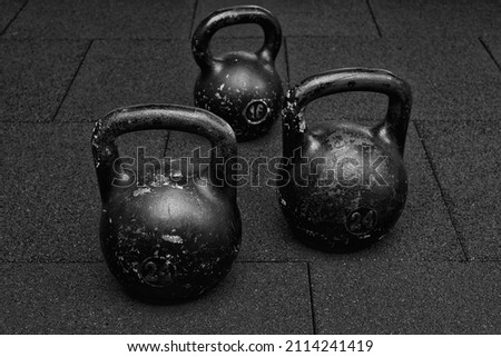three black iron kettlebell for weight training black and white photography 