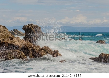 big waves hit big rocks in Tanjung Layar beach