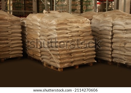 Warehouse with stacks of bags on wooden pallets. Wholesaling