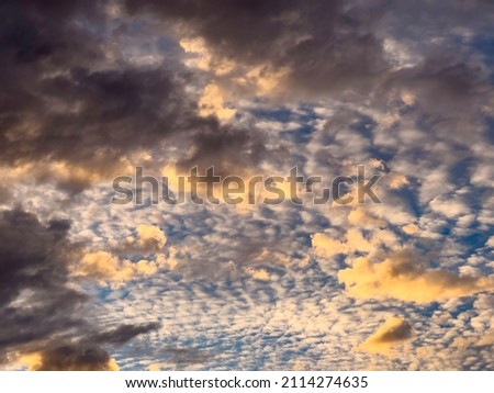 Two or three layers of clouds at sunset, for background or element with motifs of transition and change