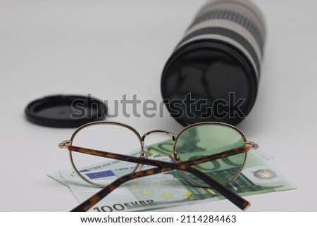 Camera, money, glasses, lens and Travel concept image: traveler accessories. Earnings on photo stocks