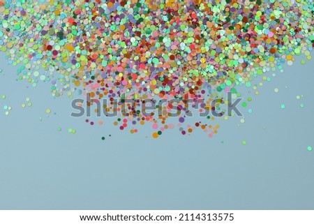 Colorful confetti on light blue background. Cute festive background