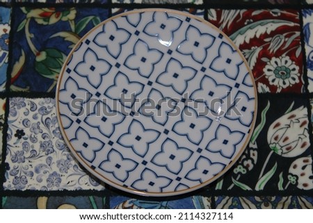 Photo of a porcelain coffee cup coaster with a deep blue tiny flower pattern