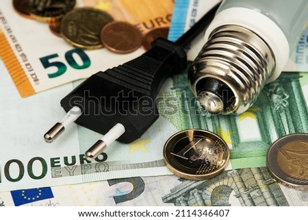 Energy costs and electricity prices. Electricity consumption concept. Euro Banknotes Energy Saving  Royalty-Free Stock Photo #2114346407