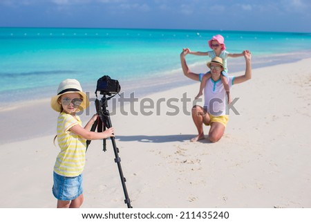 Little cute girl making photo of her family