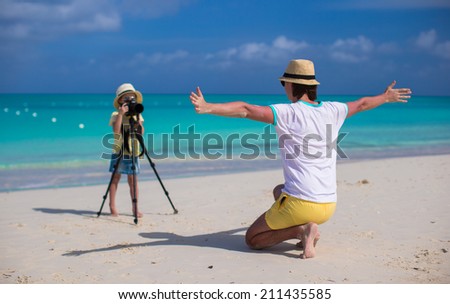 Little girl shooting with camera on tripod