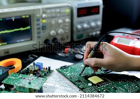 Electronics technician, electronics measuring and testing, repair and maintenance concepts. Royalty-Free Stock Photo #2114384672