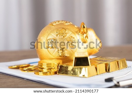 Gold and other precious metals and Taurus piggy bank.The Chinese characters in the picture mean: "to attract wealth and treasure"