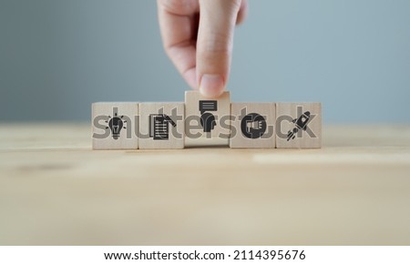 Storytelling concept. Content marketing strategy. Content visualization and visual marketing. Hand puts wooden cubes with marketing storytelling icon with idea, content, sharing and viral icons. Royalty-Free Stock Photo #2114395676