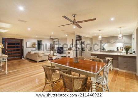 Stylish home interior with kitchen, dining and living room Royalty-Free Stock Photo #211440922