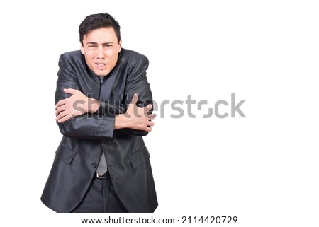 Freezing man in formal wear embracing himself
