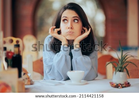 Annoyed Woman Covering Her Ears in Noisy Restaurant. Unhappy cafeteria customer complaining about the environmental noise 
 Royalty-Free Stock Photo #2114421158