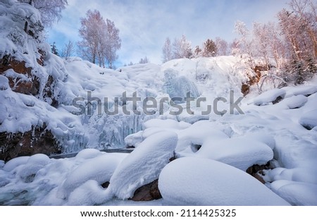 Photo of frozen waterfall on river Pescherka in winter season. Siberia, Russia
