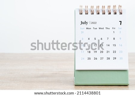 The July 2022 desk calendar on wooden background. Royalty-Free Stock Photo #2114438801