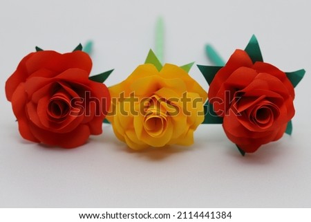 Red and yellow roses made from origami.