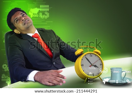 Business man resting with alarm clock and cup of tea