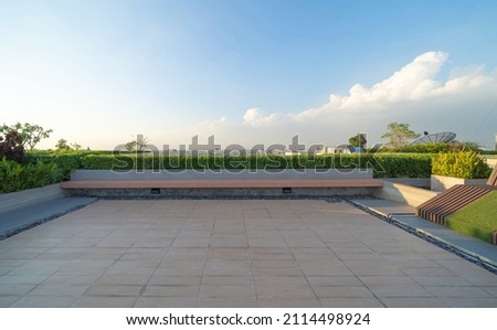 Sky garden on private rooftop of condominium or hotel, high rise architecture building with tree, grass field, and blue sky. Royalty-Free Stock Photo #2114498924