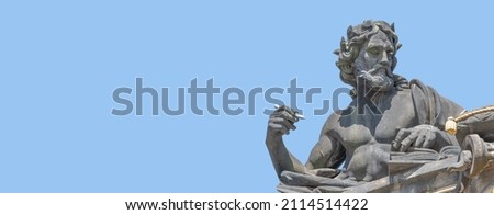 Banner with old statute of poet or writer with book, Bible, writing something at historical center of Dresden, Germany, at blue sky solid background with copy space