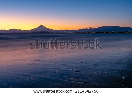 Sunset beach and beautiful mountain. Amazing colours landscape nature place in Japan. Summer beach with blue water and purple sky at the sunset.Famous palace 