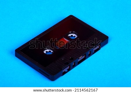 Vintage retro audio cassette tape isolated on a blue background